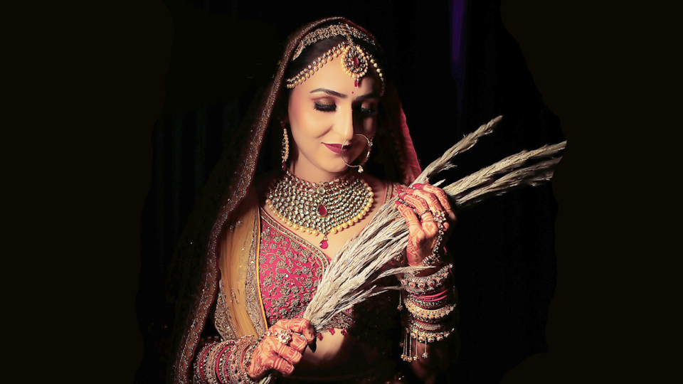 Wedding couple walking on beach at golden sunset